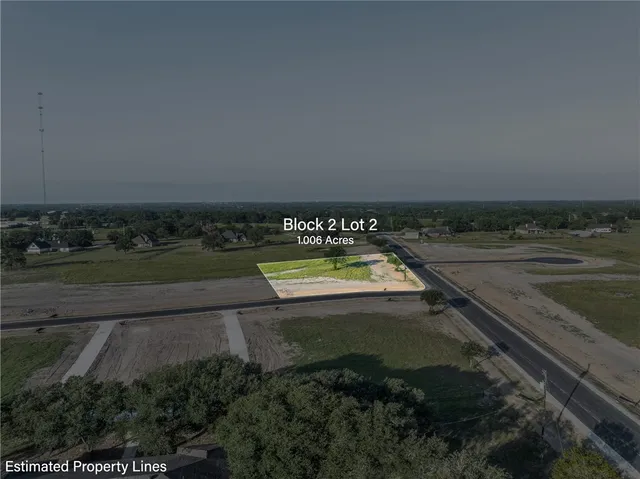 an aerial view of a houses with a yard