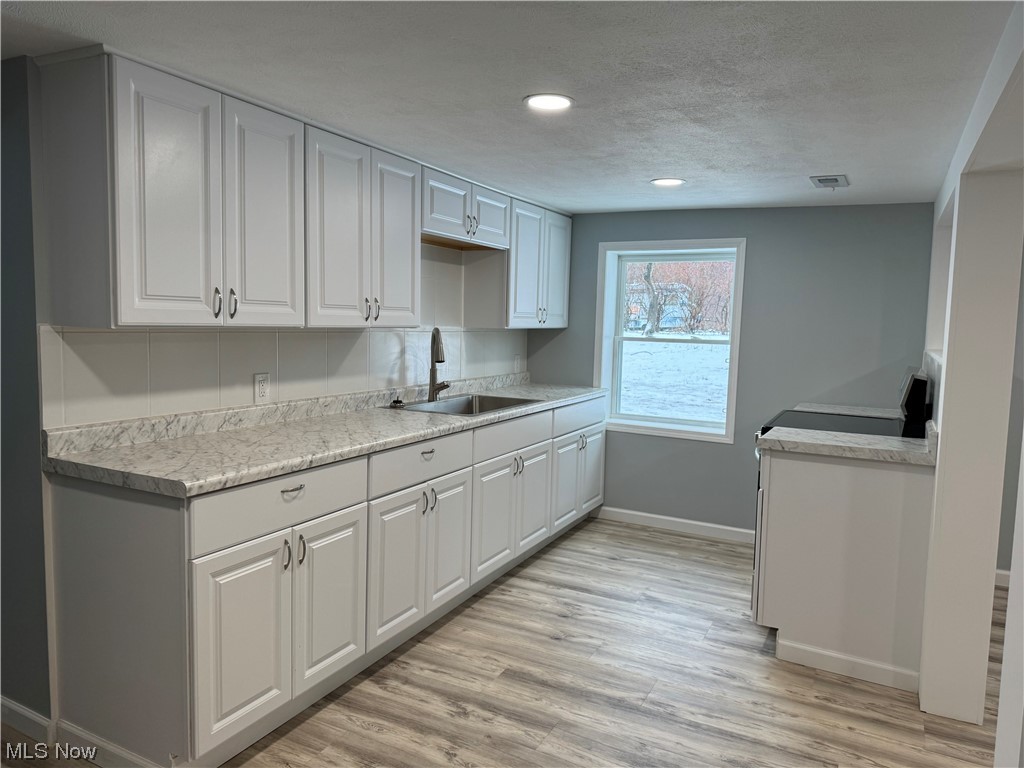 11249 Prouty Road Painesville, OH 44077 - Photo 3 of 16 Eat -In Kitchen with all new cabinets, counters, sink, lighting and appliances