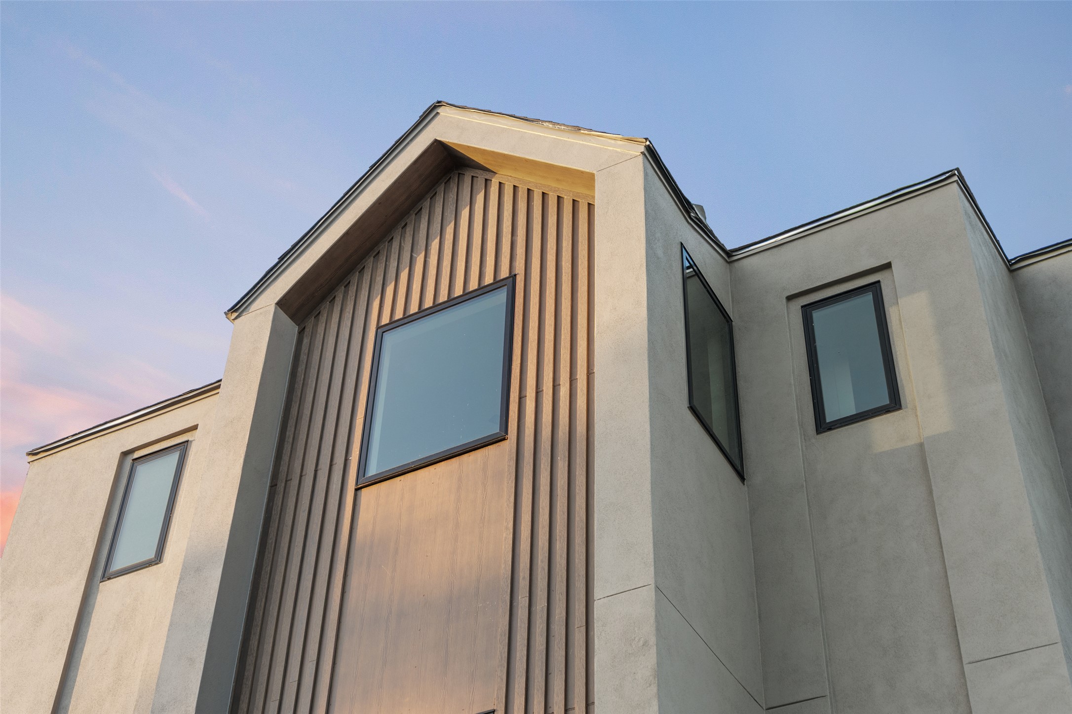 9803 Ribelin Ranch Court, Unit 19 Austin, TX 78750 - Photo 14 of 14 Modern architecture with a dramatic peak and a blend of sleek siding and plaster.