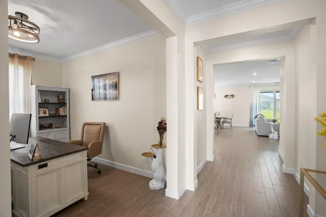 a open dining room with stainless steel appliances kitchen island granite countertop a table chairs and a wooden floor