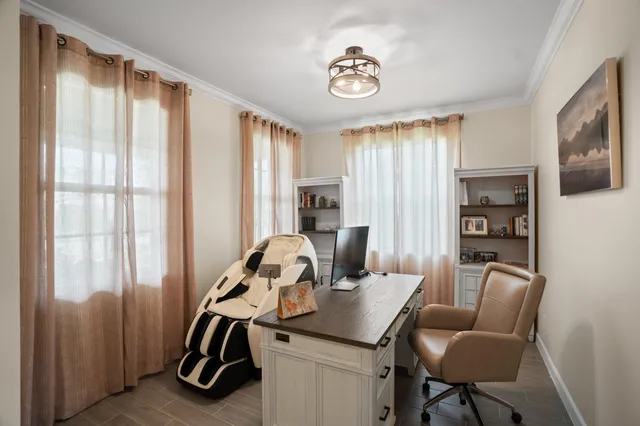a large white kitchen with a table and chairs