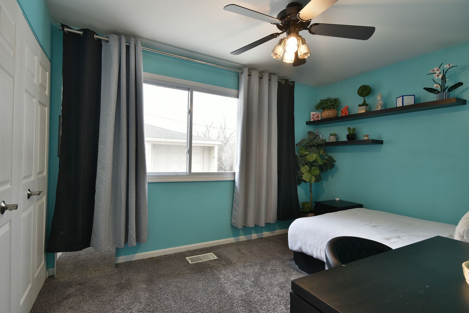 632 Merle Lane Wheeling, IL 60090 - Photo 30 of 46 a bedroom with a bed and a chandelier fan