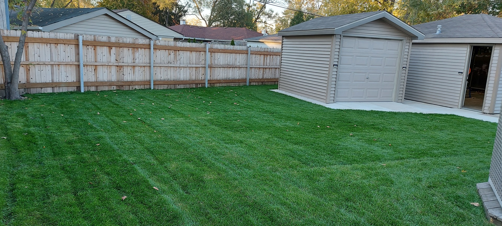 632 Merle Lane Wheeling, IL 60090 - Photo 43 of 46 a view of a white house with a yard and wooden fence