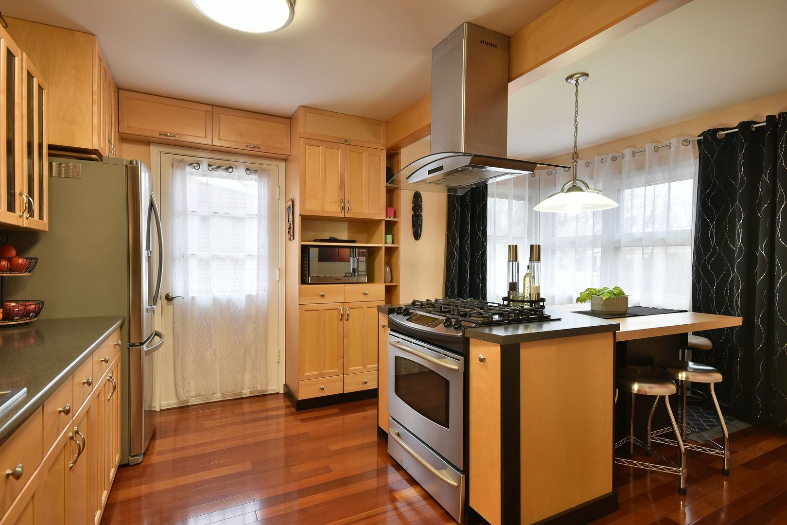 632 Merle Lane Wheeling, IL 60090 - Photo 8 of 46 a kitchen with stainless steel appliances granite countertop a stove a refrigerator and a refrigerator