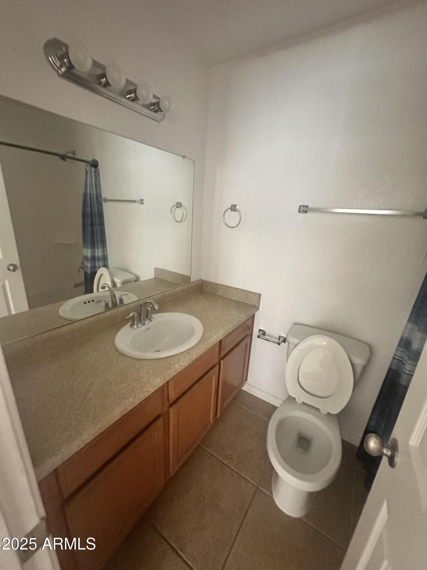 424 West Brown Road, Unit 122 Mesa, AZ 85201 - Photo 9 of 11 a bathroom with a sink toilet and mirror
