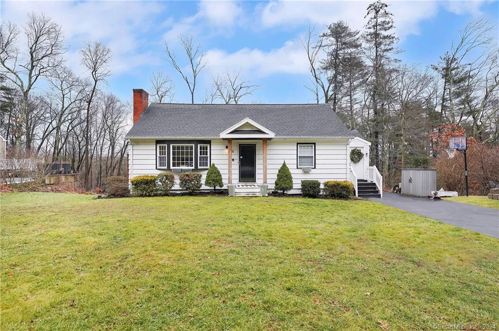a front view of a house with a garden