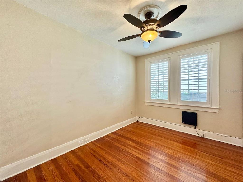 3112 West Palmira Avenue Tampa, FL 33629 - Photo 17 of 37 a view of an empty room with window and wooden floor
