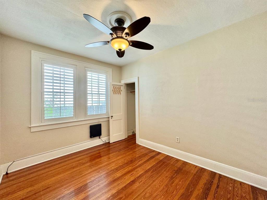 3112 West Palmira Avenue Tampa, FL 33629 - Photo 18 of 37 a view of an empty room with wooden floor and a window