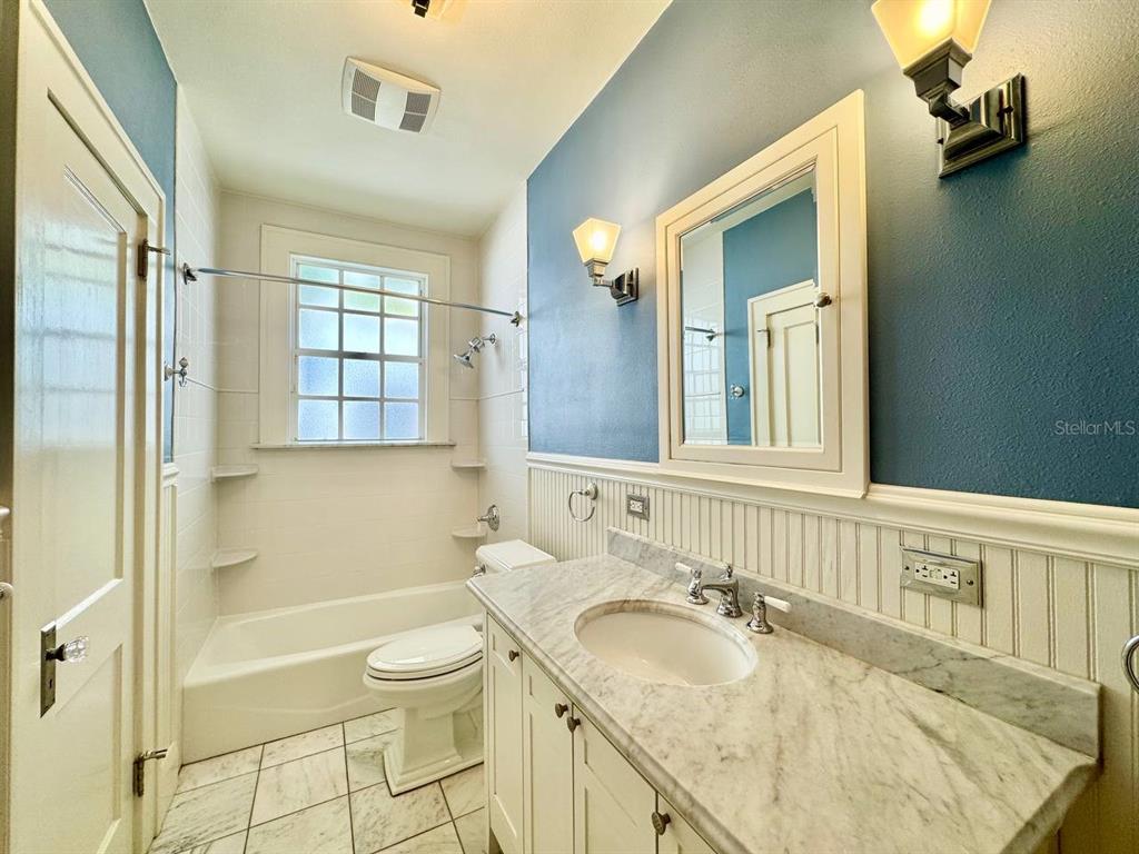 3112 West Palmira Avenue Tampa, FL 33629 - Photo 21 of 37 a bathroom with a granite countertop sink a toilet and shower