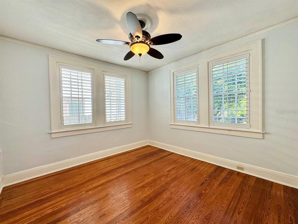 3112 West Palmira Avenue Tampa, FL 33629 - Photo 22 of 37 a view of an empty room with wooden floor and a window
