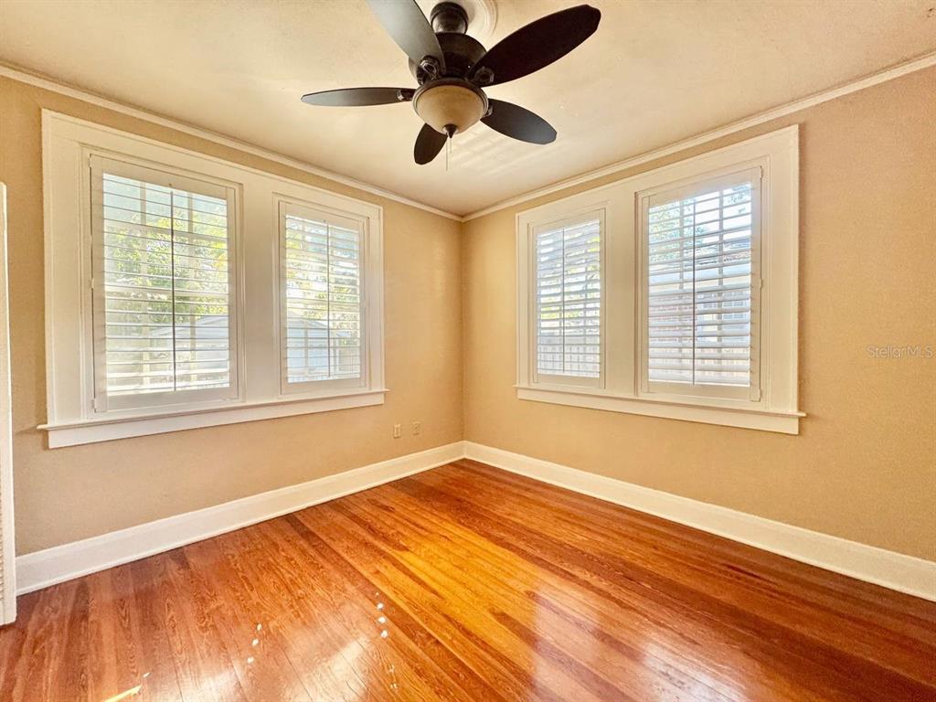 3112 West Palmira Avenue Tampa, FL 33629 - Photo 25 of 37 a view of an empty room with a window and wooden floor