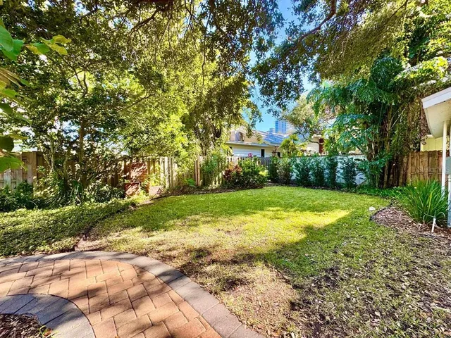 a view of yard with swimming pool and green space