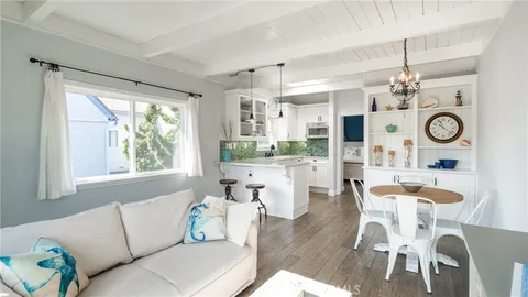 a living room with kitchen island furniture and a large window