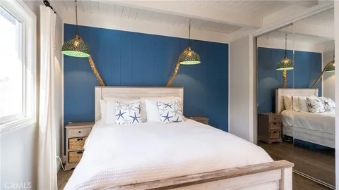 a bedroom with a bed and a mirror