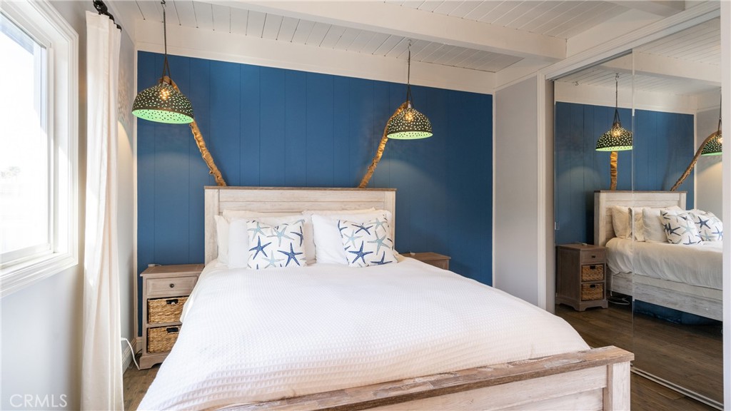 5510 Driftwood Street, Unit 4 Oxnard, CA 93035 - Photo 11 of 23 a bedroom with a bed and a mirror