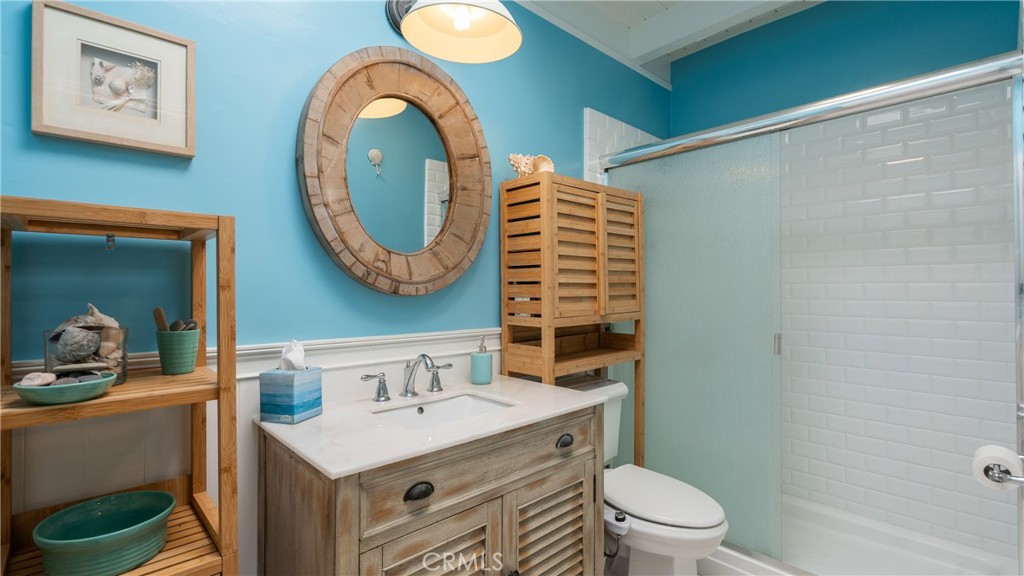 5510 Driftwood Street, Unit 4 Oxnard, CA 93035 - Photo 12 of 23 a bathroom with a toilet sink and mirror