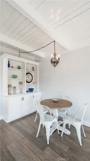 a dining room with a wooden table and chairs
