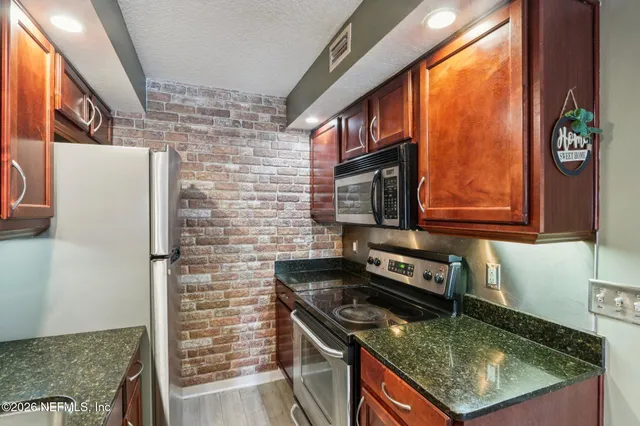 a kitchen with a refrigerator and a sink