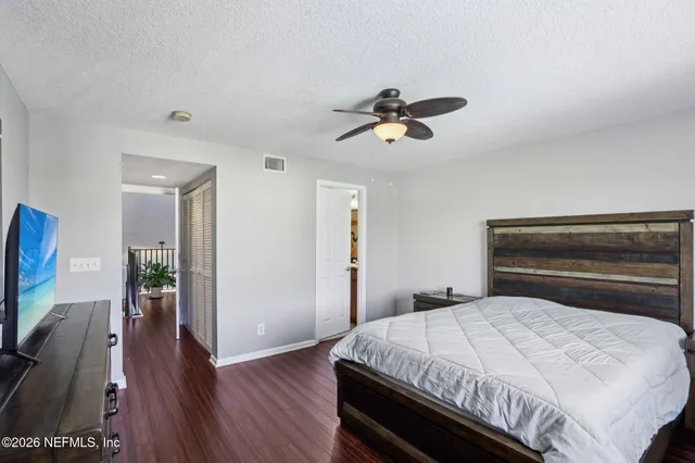 a bedroom with a bed and wooden floor