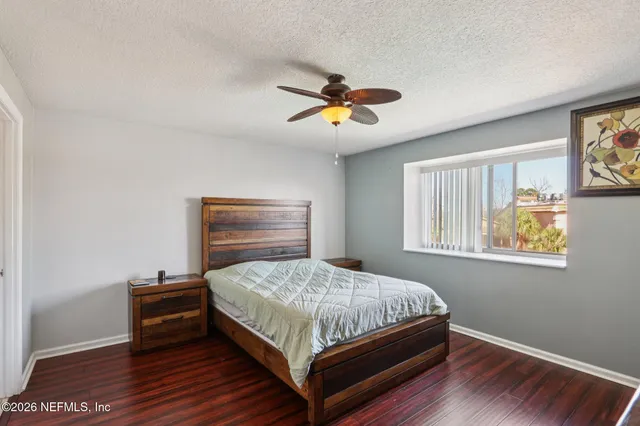 a bathroom with a granite countertop sink a toilet and a mirror