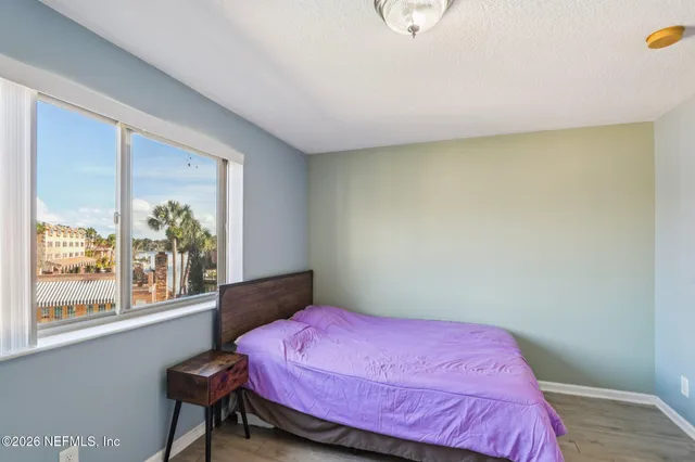 a bathroom with a granite countertop sink a mirror and a shower