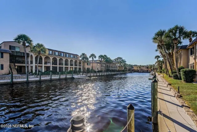 a view of a swimming pool with a lounge chair and floor to ceiling window