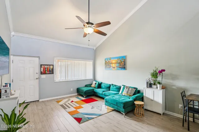 a living room with furniture and wooden floor
