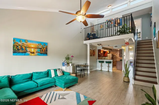 a view of entryway livingroom and hall with wooden floor