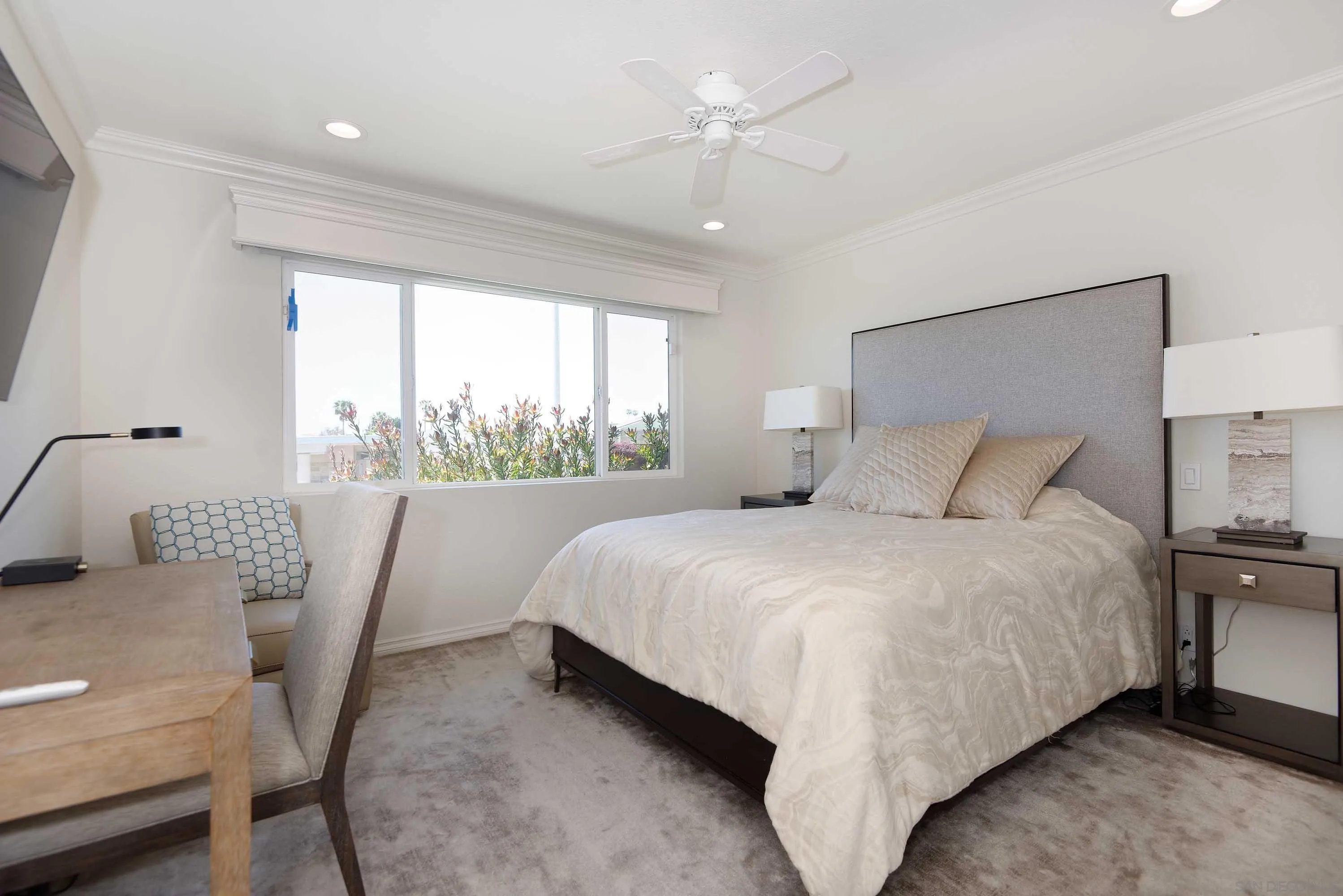 5459 Moonlight Lane La Jolla, CA 92037 - Photo 24 of 32 a large bed sitting in a bedroom next to a window