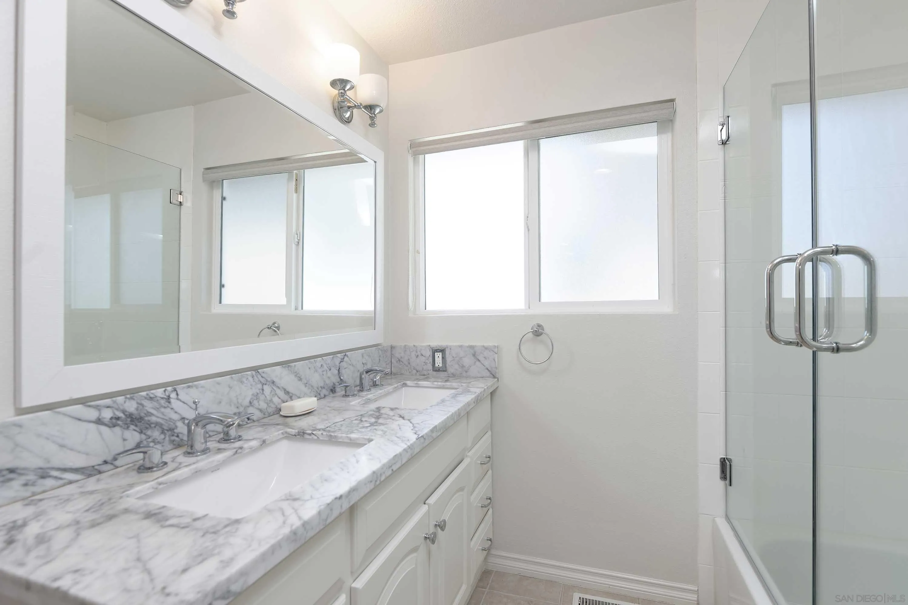 5459 Moonlight Lane La Jolla, CA 92037 - Photo 25 of 32 a bathroom with a granite countertop sink and a mirror