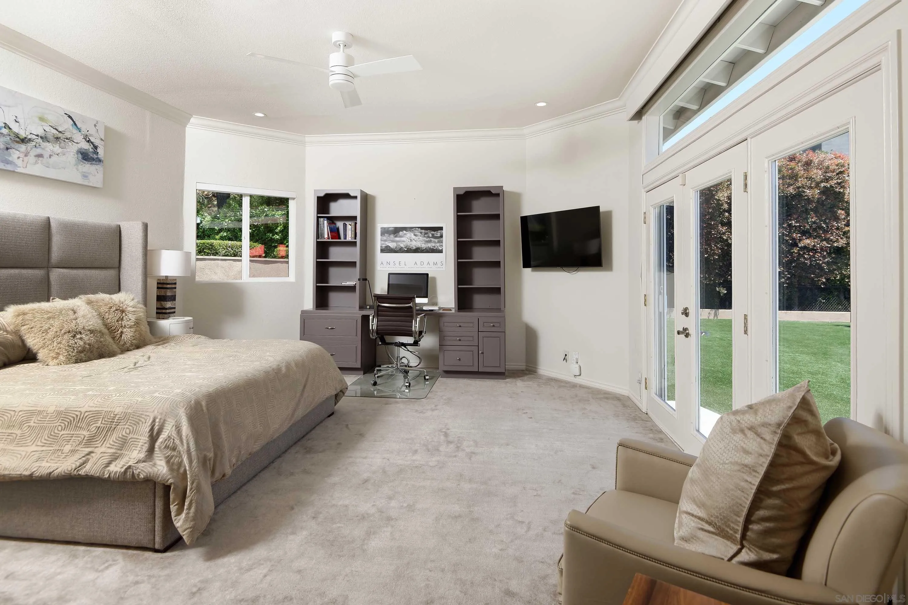 5459 Moonlight Lane La Jolla, CA 92037 - Photo 26 of 32 a spacious bedroom with a large bed and a flat screen tv