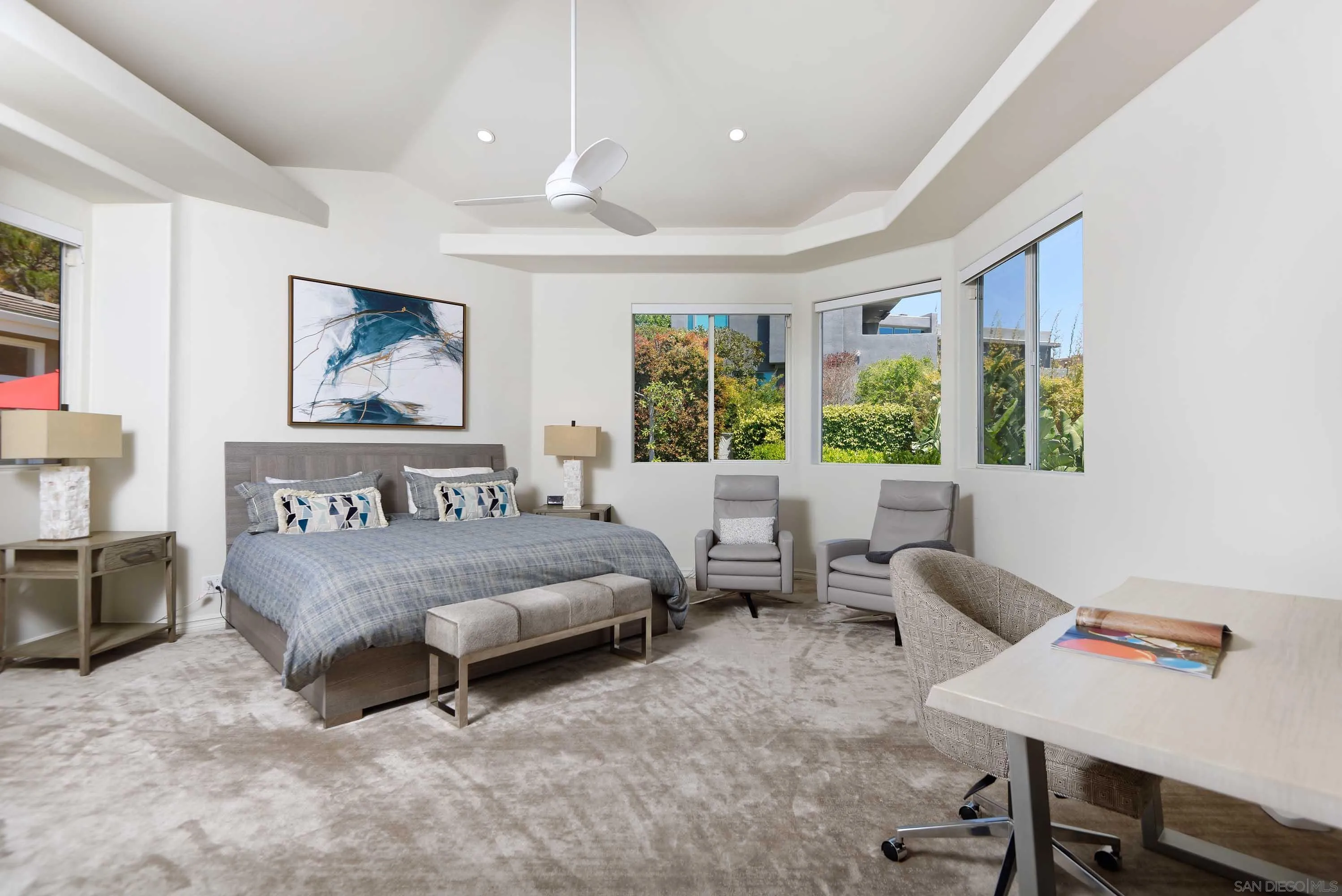 5459 Moonlight Lane La Jolla, CA 92037 - Photo 27 of 32 a spacious bedroom with a bed a table and a large window