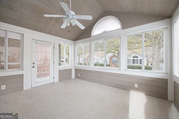 a view of empty room with a ceiling fan and window