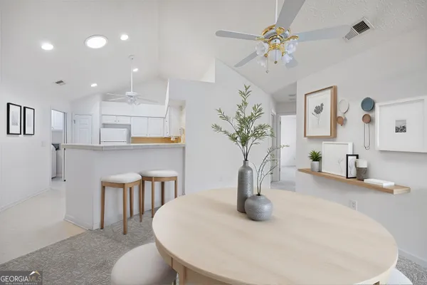 a view of a kitchen with a sink dishwasher a refrigerator and a chandelier