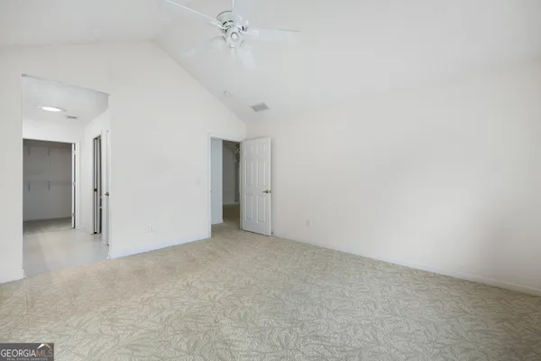 a spacious bathroom with a double vanity sink and a mirror