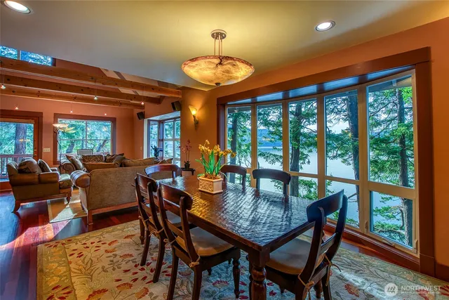 a dining room with furniture a rug and a large window