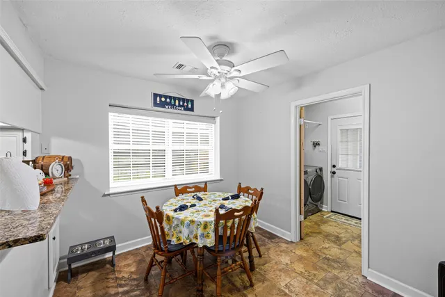 a view of a dining room with furniture window and outside view