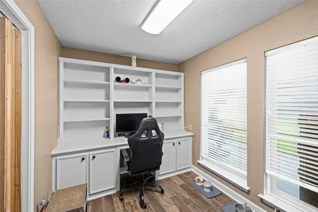 a view of a workspace with furniture and a window