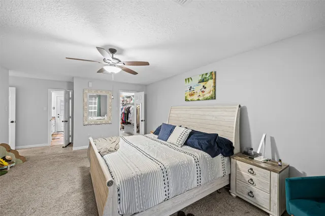 a bedroom with bed and a chandelier