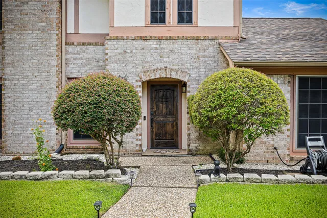 a front view of a house with garden