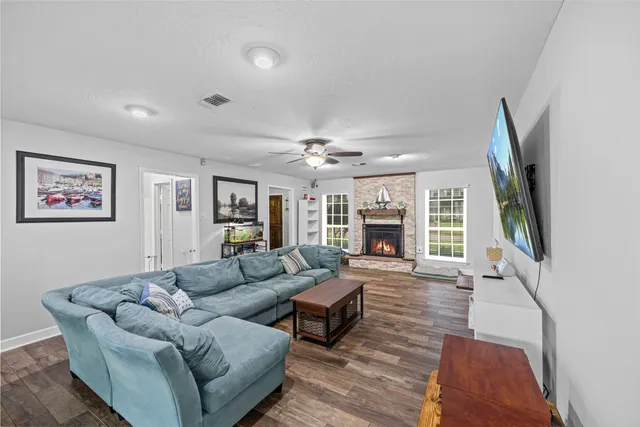 a living room with furniture large window and flat screen tv