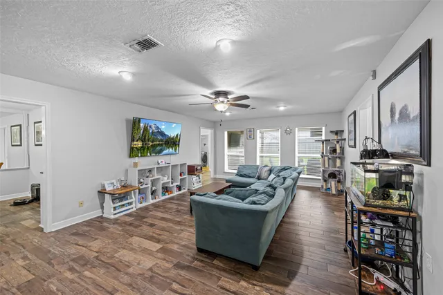 a living room with fireplace furniture and a flat screen tv