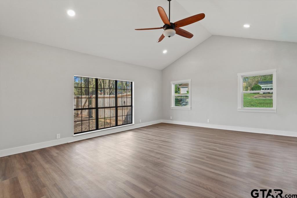 2819 New Copeland Road Tyler, TX 75701 - Photo 18 of 39 an empty room with wooden floor ceiling fan and windows
