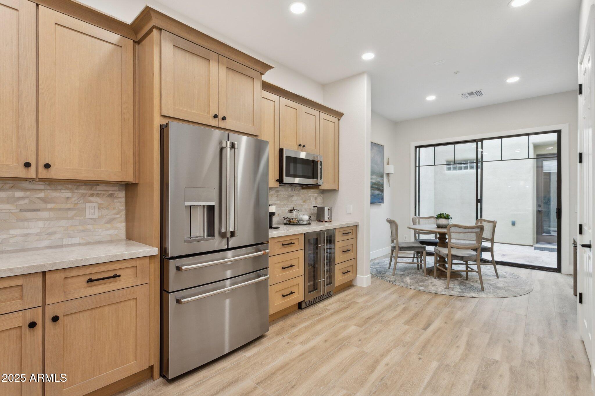 9270 East Thompson Peak Parkway, Unit 364 Scottsdale, AZ 85255 - Photo 11 of 45 a kitchen with granite countertop cabinets stainless steel appliances and dining table
