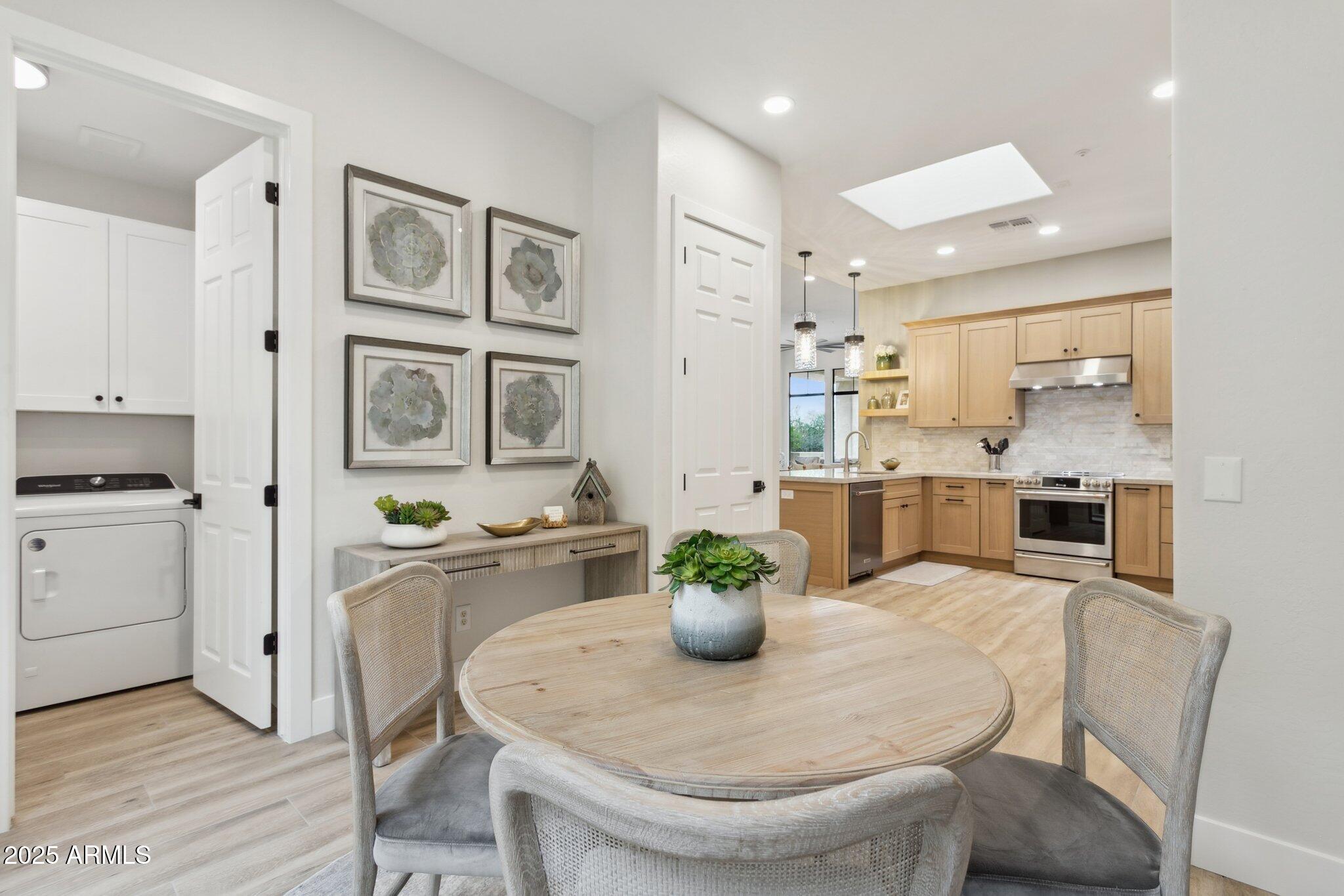 9270 East Thompson Peak Parkway, Unit 364 Scottsdale, AZ 85255 - Photo 12 of 45 a kitchen with stainless steel appliances granite countertop a dining table chairs and view of living room