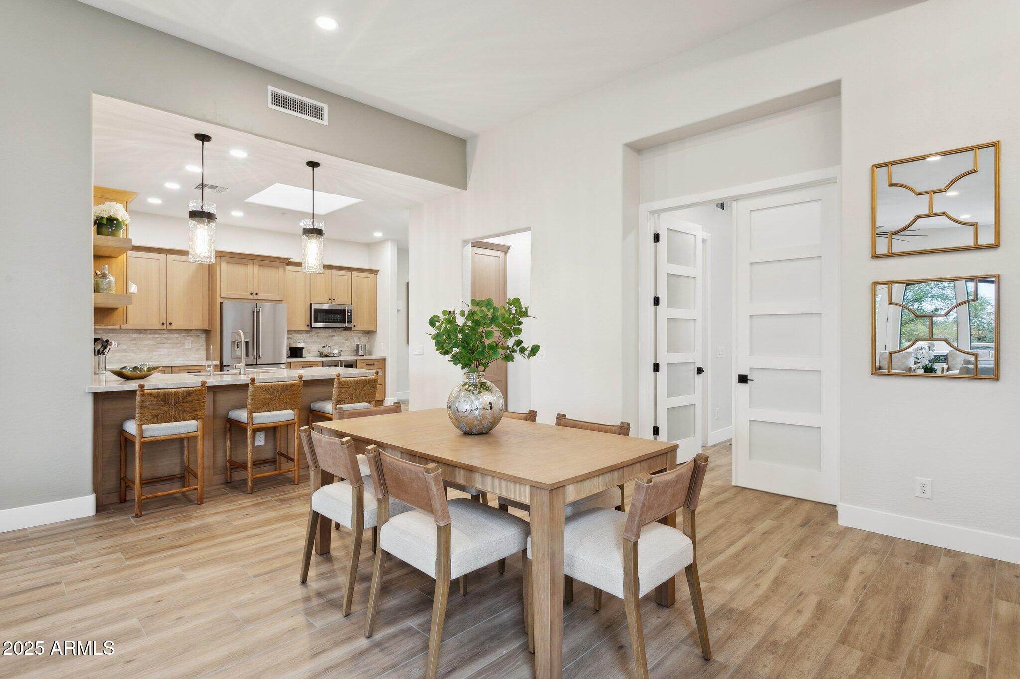 9270 East Thompson Peak Parkway, Unit 364 Scottsdale, AZ 85255 - Photo 14 of 45 a view of a dining room with furniture and wooden floor