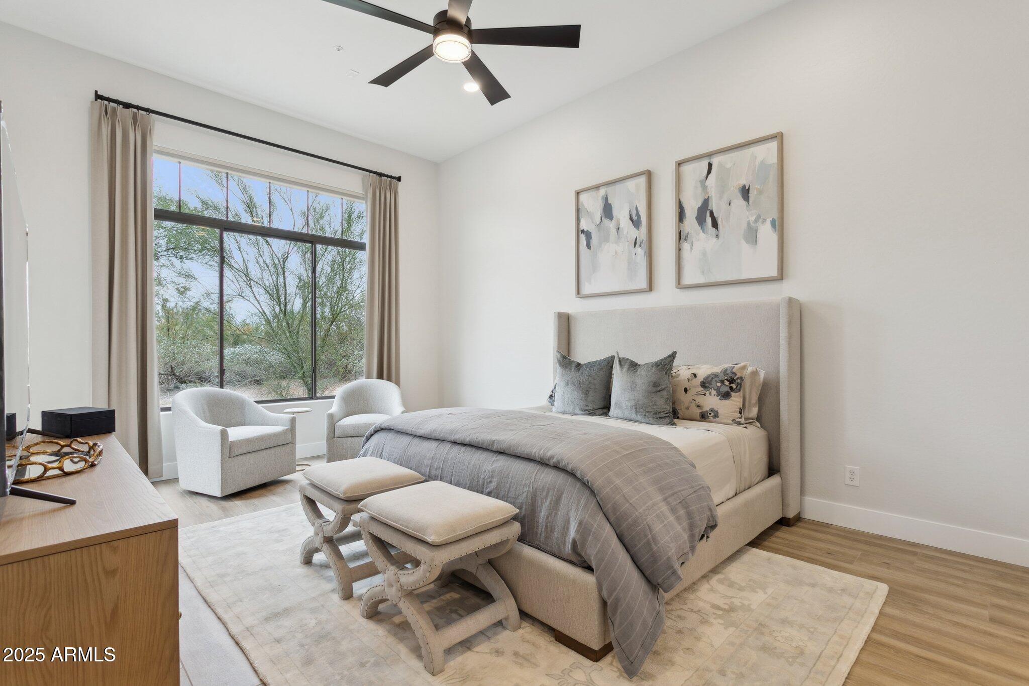 9270 East Thompson Peak Parkway, Unit 364 Scottsdale, AZ 85255 - Photo 15 of 45 a bedroom with a bed and a chandelier