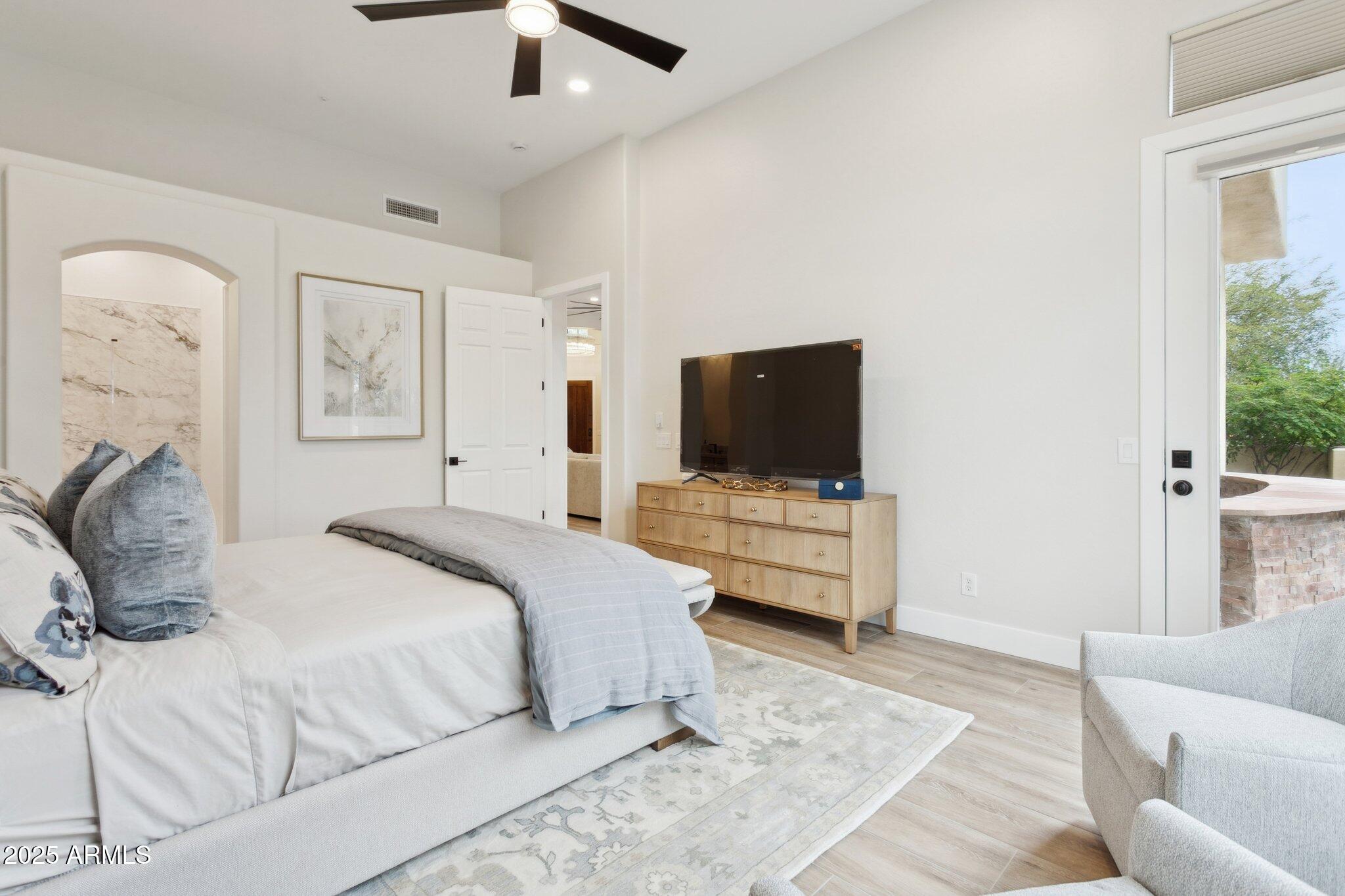 9270 East Thompson Peak Parkway, Unit 364 Scottsdale, AZ 85255 - Photo 16 of 45 a bedroom with a bed and a flat screen tv