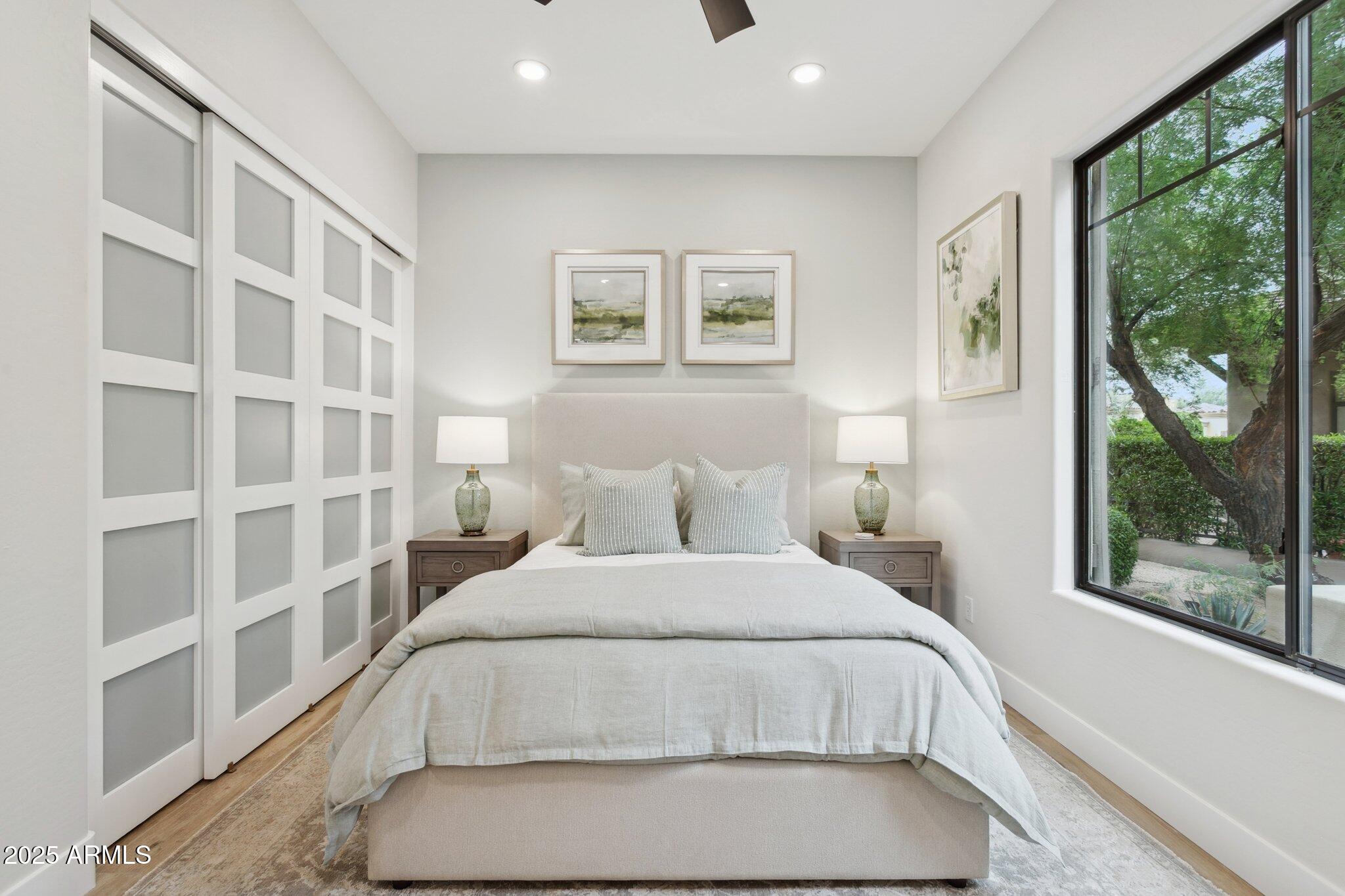 9270 East Thompson Peak Parkway, Unit 364 Scottsdale, AZ 85255 - Photo 19 of 45 a bedroom with a large bed and a large window