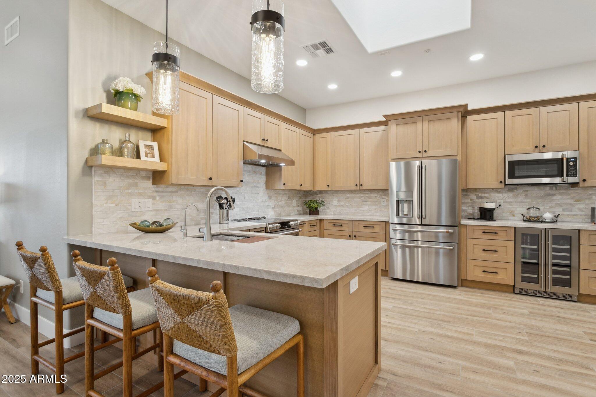 9270 East Thompson Peak Parkway, Unit 364 Scottsdale, AZ 85255 - Photo 2 of 45 a kitchen with refrigerator cabinets and wooden floor